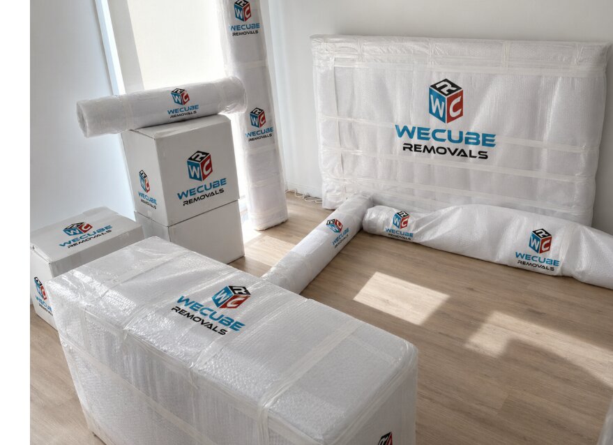 WECUBE crew in hi-vis packing cartons at a customer's home